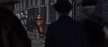 Movie still from “The Power of the Dog” (2021), directed by Jane Campion – A woman in a fur coat and a man in a suit and hat; Wide shot, Over the shoulder angle