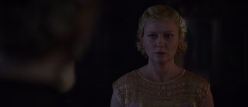 Movie still from “The Power of the Dog” (2021), directed by Jane Campion – A woman with blonde hair wearing a yellow dress; Close Up shot, Over the shoulder angle