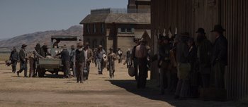 Movie still from “The Power of the Dog” (2021), directed by Jane Campion – A group of people walking down a dirt road; Wide shot, Over the shoulder angle