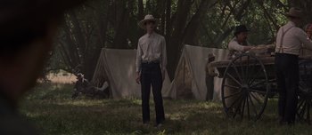 Movie still from “The Power of the Dog” (2021), directed by Jane Campion – A man standing in the woods; Wide shot, Low angle