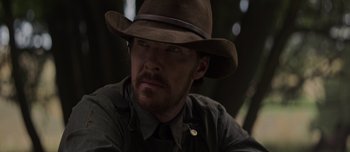 Movie still from “The Power of the Dog” (2021), directed by Jane Campion – A man wearing a brown hat and a black shirt; Close Up shot, Over the shoulder angle