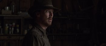 Movie still from “The Power of the Dog” (2021), directed by Jane Campion – A man wearing a hat and looking to his left; Close Up shot, Over the shoulder angle