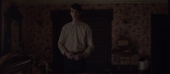 Movie still from “The Power of the Dog” (2021), directed by Jane Campion – A young man standing in front of a door; Medium shot, Over the shoulder angle