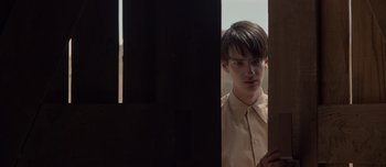 Movie still from “The Power of the Dog” (2021), directed by Jane Campion – A man standing in front of a window; Close Up shot, Over the shoulder angle