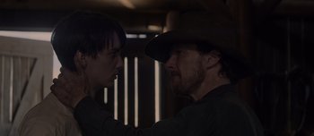 Movie still from “The Power of the Dog” (2021), directed by Jane Campion – A man in a cowboy hat and another man in a cowboy hat; Close Up shot, Over the shoulder angle