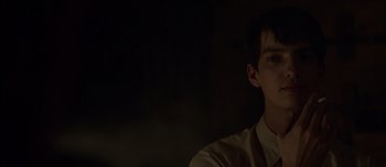 Movie still from “The Power of the Dog” (2021), directed by Jane Campion – A man in a white shirt is in a dark room; Close Up shot, Over the shoulder angle