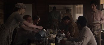 Movie still from “The Power of the Dog” (2021), directed by Jane Campion – A group of people sitting around a table; Medium shot, Over the shoulder angle