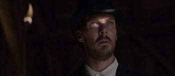 Movie still from “The Power of the Dog” (2021), directed by Jane Campion – A person wearing a suit and a hat; Close Up shot, Low angle