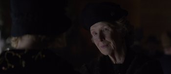 Movie still from “The Power of the Dog” (2021), directed by Jane Campion – An older woman wearing a black hat looking at the camera; Close Up shot, Over the shoulder angle