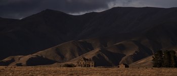 Movie still from “The Power of the Dog” (2021), directed by Jane Campion – An abandoned house in the middle of a field; Extreme Wide shot, Low angle