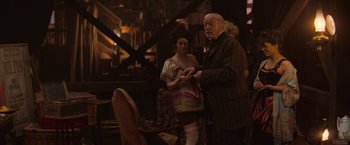 Movie still from “The Prestige” (2006), directed by Christopher Nolan – An older man and a young woman standing next to each other; Medium shot, Over the shoulder angle