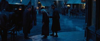 Movie still from “The Prestige” (2006), directed by Christopher Nolan – A man and a woman are walking in the dark; Medium shot, Over the shoulder angle