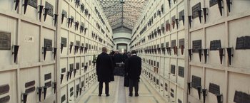 Movie still from “The Prestige” (2006), directed by Christopher Nolan – A group of people standing in a room; Wide shot, High angle