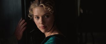 Movie still from “The Prestige” (2006), directed by Christopher Nolan – A beautiful young lady wearing a green dress; Close Up shot, Over the shoulder angle