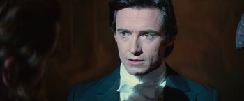 Movie still from “The Prestige” (2006), directed by Christopher Nolan – A person wearing a suit and tie; Close Up shot, Over the shoulder angle