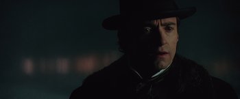 Movie still from “The Prestige” (2006), directed by Christopher Nolan – A person wearing a top hat; Close Up shot, Over the shoulder angle
