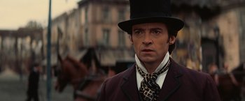 Movie still from “The Prestige” (2006), directed by Christopher Nolan – A person wearing a top hat; Close Up shot, Low angle
