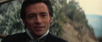 Movie still from “The Prestige” (2006), directed by Christopher Nolan – A person wearing a suit and tie; Close Up shot, Over the shoulder angle