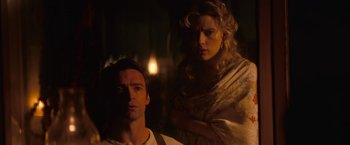 Movie still from “The Prestige” (2006), directed by Christopher Nolan – A man and a woman standing next to each other in the dark; Medium shot, Low angle