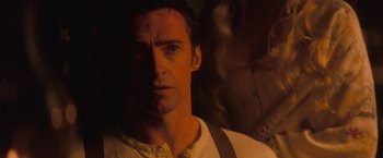 Movie still from “The Prestige” (2006), directed by Christopher Nolan – A person wearing a white shirt and suspenders; Close Up shot, Over the shoulder angle