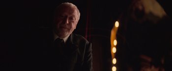 Movie still from “The Prestige” (2006), directed by Christopher Nolan – An older man in a suit and tie; Close Up shot, Low angle