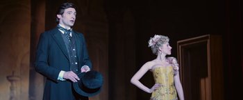 Movie still from “The Prestige” (2006), directed by Christopher Nolan – A man and a woman dressed up in costumes; Medium shot, Low angle