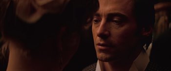 Movie still from “The Prestige” (2006), directed by Christopher Nolan – A man's face in the dark; Close Up shot, Over the shoulder angle