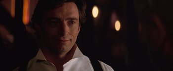 Movie still from “The Prestige” (2006), directed by Christopher Nolan – A person wearing a white shirt; Close Up shot, Over the shoulder angle