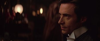 Movie still from “The Prestige” (2006), directed by Christopher Nolan – Close up of a man looking to his left; Close Up shot, Over the shoulder angle