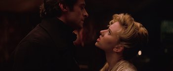 Movie still from “The Prestige” (2006), directed by Christopher Nolan – A man and a woman face to face in a dark room; Close Up shot, Low angle