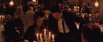 A man and a woman looking at candles on a table