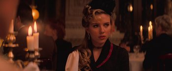 Movie still from “The Prestige” (2006), directed by Christopher Nolan – A woman with a long blonde curly hair; Close Up shot, Over the shoulder angle