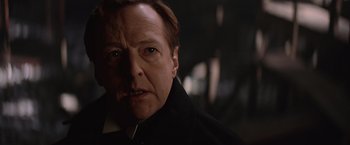 Movie still from “The Prestige” (2006), directed by Christopher Nolan – A person wearing a suit and tie; Close Up shot, Over the shoulder angle