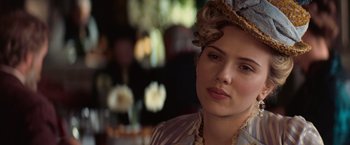 Movie still from “The Prestige” (2006), directed by Christopher Nolan – A woman in a hat and a dress; Close Up shot, Over the shoulder angle