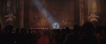 Movie still from “The Prestige” (2006), directed by Christopher Nolan – A crowd of people watching a man stand on a stage; Extreme Wide shot, High angle