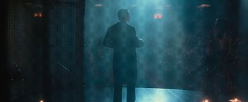 Movie still from “The Prestige” (2006), directed by Christopher Nolan – A man standing on a stage in front of an audience; Wide shot, Low angle