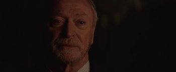 Movie still from “The Prestige” (2006), directed by Christopher Nolan – An older man with a beard and a suit; Close Up shot, Over the shoulder angle