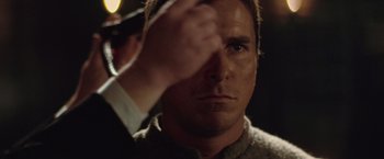 Movie still from “The Prestige” (2006), directed by Christopher Nolan – A person holding a hand up; Close Up shot, Over the shoulder angle