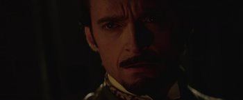Movie still from “The Prestige” (2006), directed by Christopher Nolan – A person with a mustache; Close Up shot, Over the shoulder angle