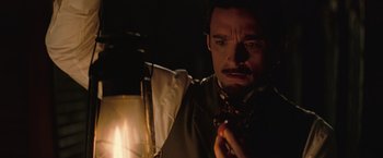 Movie still from “The Prestige” (2006), directed by Christopher Nolan – A person wearing a suit and tie; Close Up shot, Over the shoulder angle