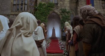 Movie still from “The Princess Bride” (1987), directed by Rob Reiner – A group of people standing in front of a red carpet; Wide shot, Low angle
