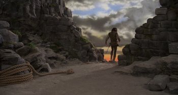 Movie still from “The Princess Bride” (1987), directed by Rob Reiner – A man walking on a dirt road near a rock wall; Wide shot, Low angle