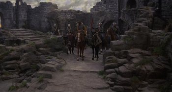 Movie still from “The Princess Bride” (1987), directed by Rob Reiner – A group of men riding horses through a stone wall; Extreme Wide shot, High angle