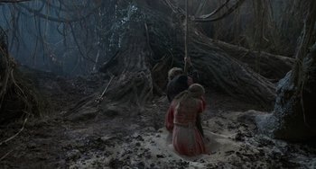 Movie still from “The Princess Bride” (1987), directed by Rob Reiner – A group of people standing in the dirt near a tree; Wide shot, High angle