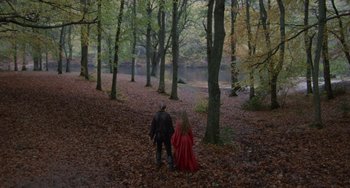 Movie still from “The Princess Bride” (1987), directed by Rob Reiner – A man and a woman dressed in medieval garb walking through a wooded area; Extreme Wide shot, High angle
