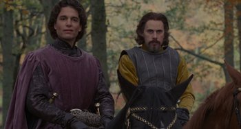 Movie still from “The Princess Bride” (1987), directed by Rob Reiner – Two men in medieval garb standing next to each other; Medium shot, Low angle