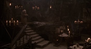 Movie still from “The Princess Bride” (1987), directed by Rob Reiner – A dark room with candles lit in the middle of the room; Extreme Wide shot, High angle