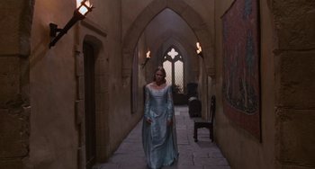 Movie still from “The Princess Bride” (1987), directed by Rob Reiner – A woman dressed in medieval clothing walking down a hall way; Wide shot, High angle