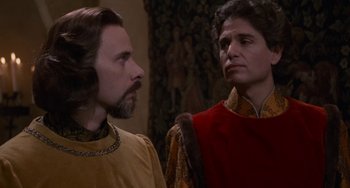 Movie still from “The Princess Bride” (1987), directed by Rob Reiner – Two men standing next to each other in front of a painting; Close Up shot, Over the shoulder angle