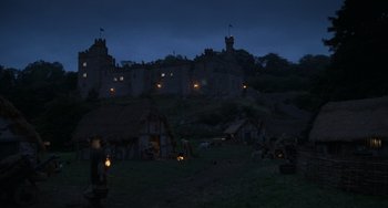 Movie still from “The Princess Bride” (1987), directed by Rob Reiner – A medieval village with a castle in the background at night time; Extreme Wide shot, Low angle